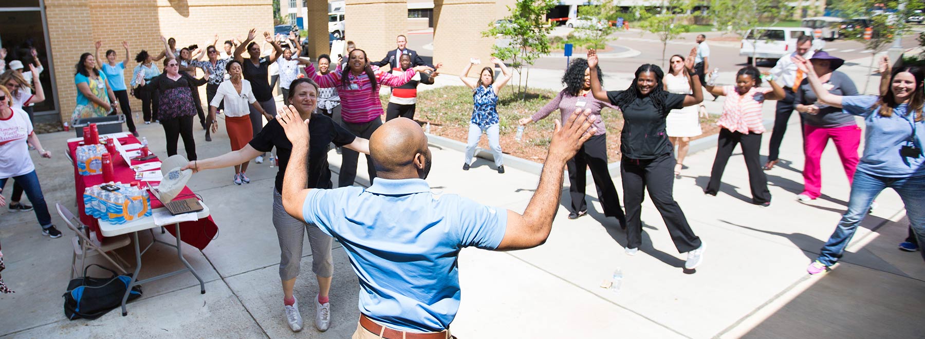 Educator leads a group in outdoor exercise